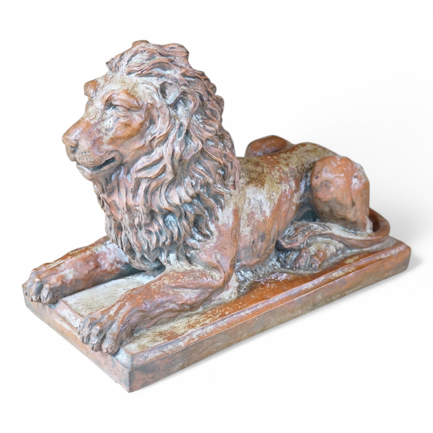 A terracotta sculpture of a lion, 39cm wide. Condition - good